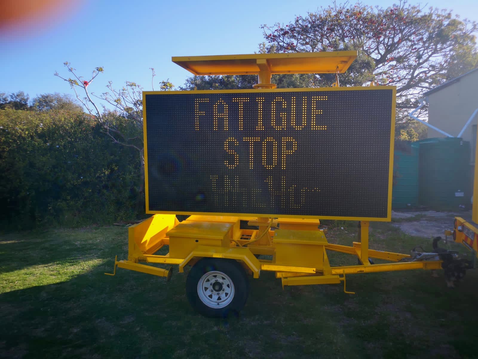 Trailer-mounted variable message sign deployed beside a roadway